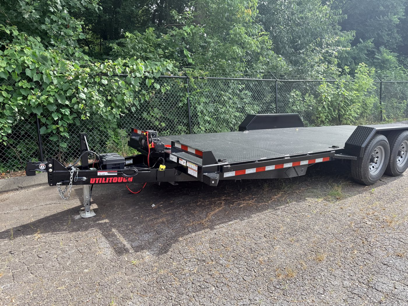 The 2026 Hawke 20-foot power-tilt steel-deck car hauler, full side view on the lot in Hickory, NC