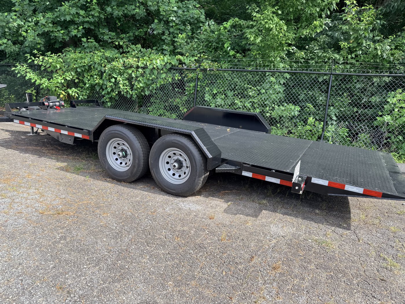 The Hawke hauler with its deck power-tilted down flat to the ground for easy loading