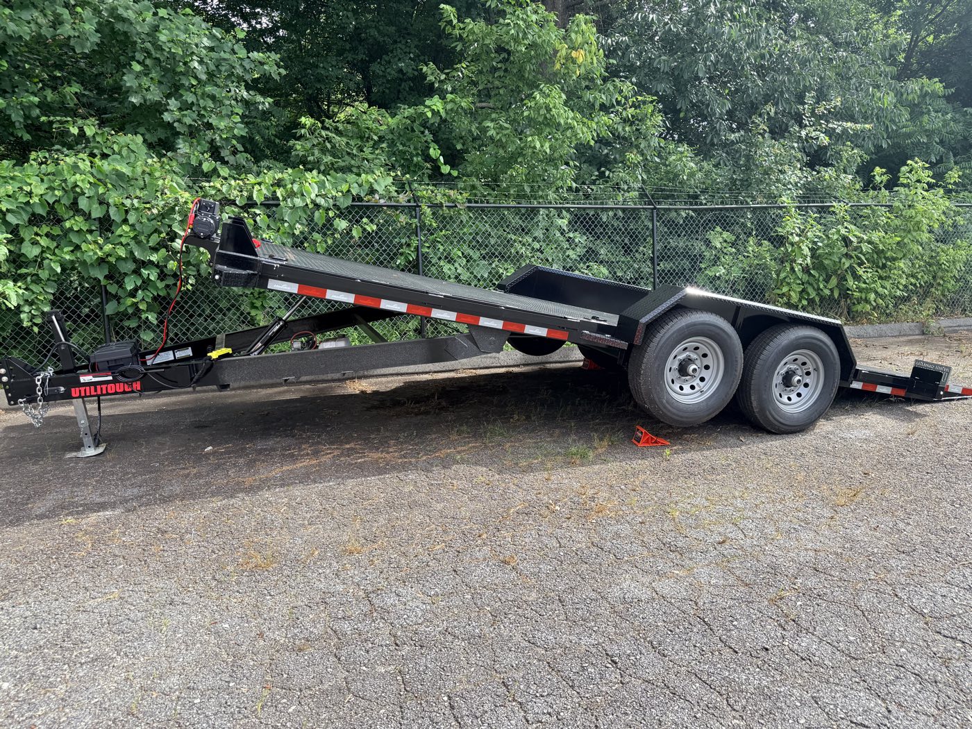 Side profile of the trailer mid-tilt showing the low knife-edge tail angle