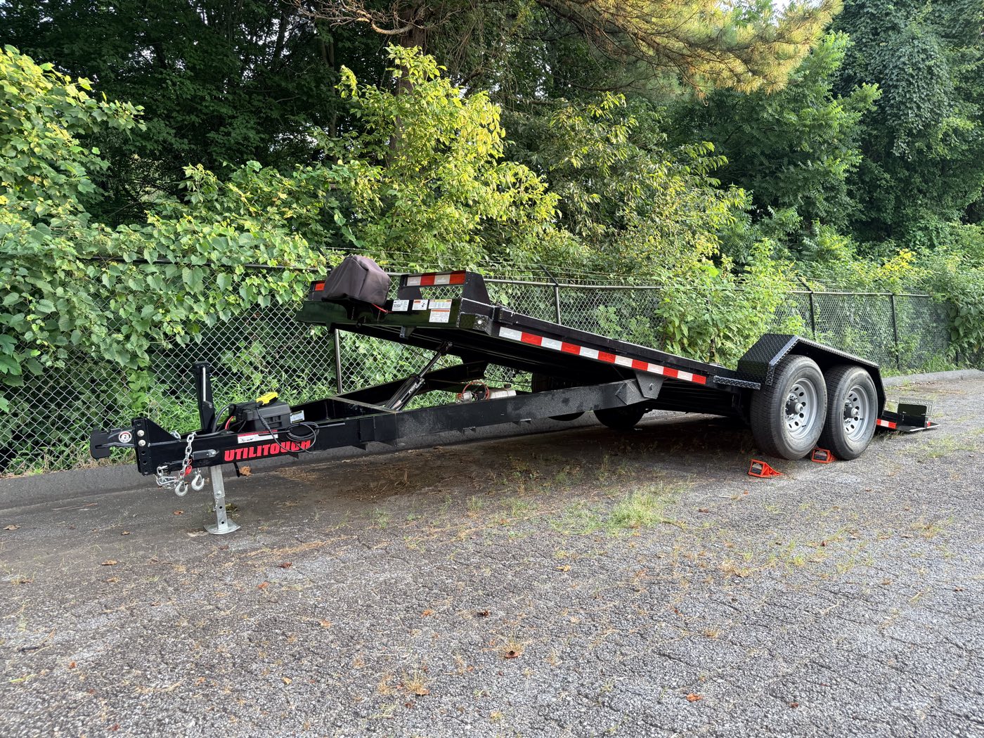 The 2026 Hawke 20-foot power-tilt steel-deck car hauler, full side profile with the deck raised, in Hickory, NC